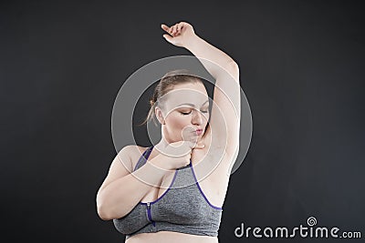 Young happy plus size caucasian woman shows her unshaved armpit Stock Photo