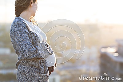 Young happy pregnant woman outdoor autumn day Stock Photo