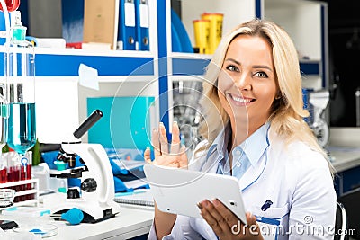 Young attractive woman scientist using tablet computer in the la Stock Photo