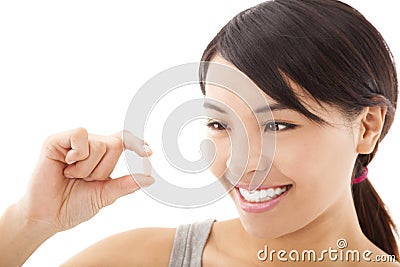 Young happy smiling woman showing vitamin Stock Photo