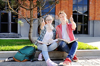 Young students show sight thumbs up and good luck Stock Photo