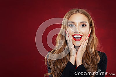 Young happy woman against red wall background. Surprised girl portrait. Positive emotions, facial expression Stock Photo