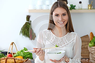 Young happy woman cooking in the kitchen. Healthy meal, lifestyle and culinary concepts. Good morning begins with fresh Stock Photo