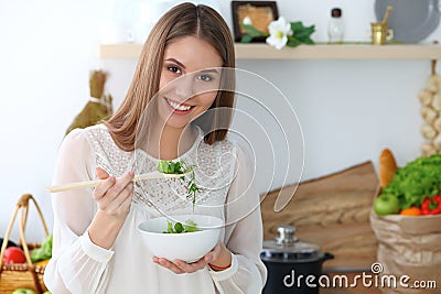 Young happy woman cooking in the kitchen. Healthy meal, lifestyle and culinary concepts. Good morning begins with fresh Stock Photo