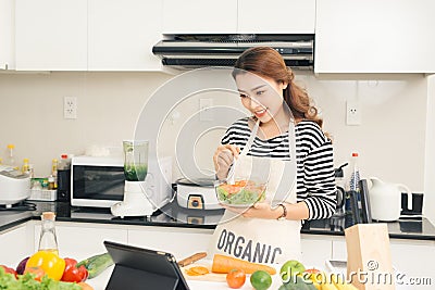 Young happy woman eating salad. Healthy lifestyle with green foo Stock Photo