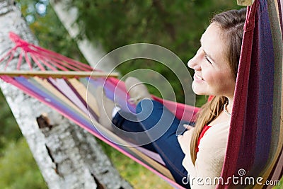 Young happy woman in hammock Stock Photo