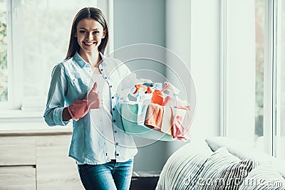 Young Happy Woman holds Cleaning Equipment at Home Stock Photo