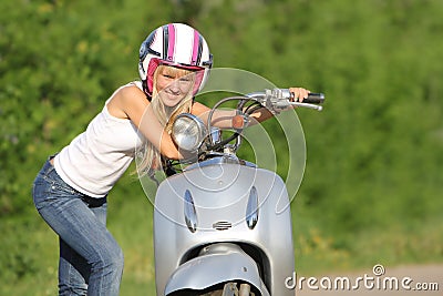 Young happy woman on scooter outdoor Stock Photo