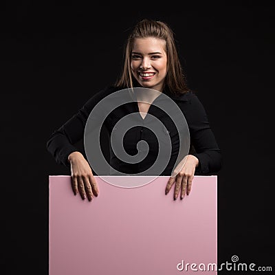 Young happy woman showing presentation, pointing on placard Stock Photo