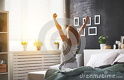 Young woman woke up in the morning in the bedroom by the windo Stock Photo