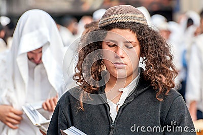 Young hasid pilgrim in the crowd on the city street. Holiday Rosh Hashanah, Jewish New Year. Editorial Stock Photo