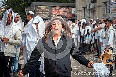 Young hasid pilgrim in the crowd on the city street. Holiday Rosh Hashanah, Jewish New Year. Editorial Stock Photo