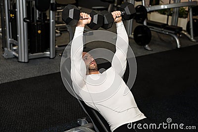 Young Healthy Man Doing Chest Exercise With Dumbbells