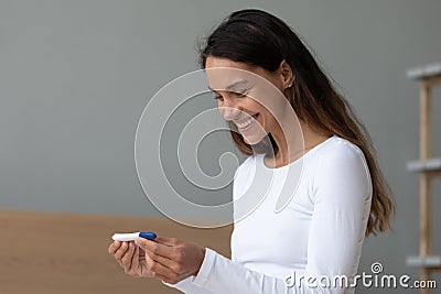 Woman holding ovulation test checks chances of getting pregnant Stock Photo