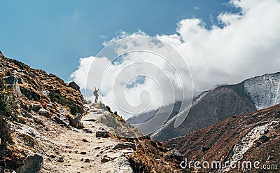 Young hiker backpacker female taking brake in hike walking during high altitude Everest Base Camp EBC route with snow Himalayan Stock Photo