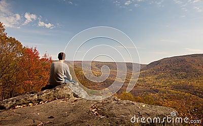 Young hiker relaxing on rock Stock Photo