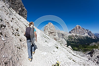 Young hiker walking on a mountain trail. Stock Photo