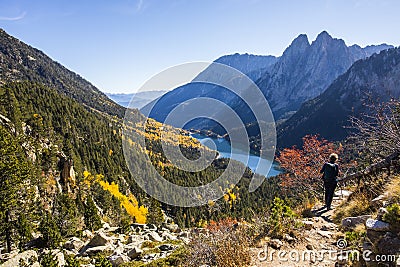 Young hiker woman in autumn in Aiguestortes and Sant Maurici National Park, Spain Editorial Stock Photo