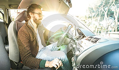 Young hipster fashion model driving car - Happy confident man with beard and alternative mustache smiling at business roadtrip - Stock Photo