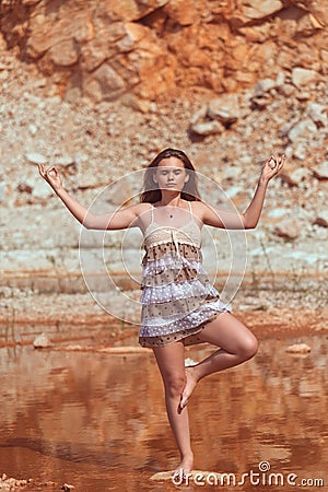 Young hipster woman alone in nature meditating with eyes closed Stock Photo