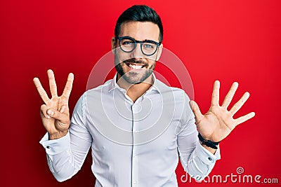 Young hispanic businessman wearing shirt and glasses showing and pointing up with fingers number eight while smiling confident and Stock Photo
