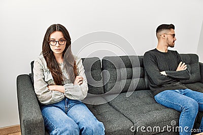 Young hispanic couple angry sitting on the sofa in silence at home Stock Photo