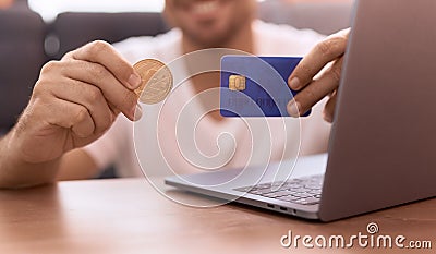 Young hispanic man holding litecoin crypto currency and credit card at home Stock Photo