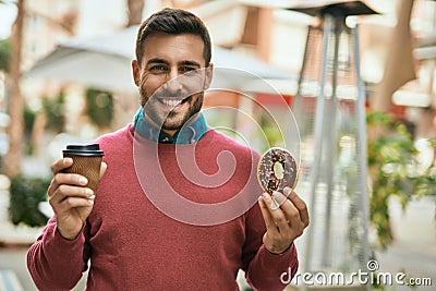 Young hispanic man smiling happy having breakfast at the city Stock Photo