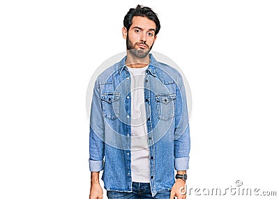 Young hispanic man wearing casual clothes looking sleepy and tired, exhausted for fatigue and hangover, lazy eyes in the morning Stock Photo