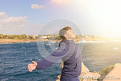 young hispanic with open arms praying to jesus, receiving spiritual blessing from our lord jesus christ, Stock Photo