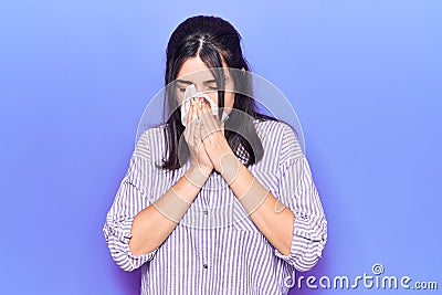 Young hispanic woman illness using paper handkerchief on nose Stock Photo