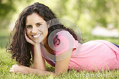 Young Hispanic Woman Relaxing In Park Stock Photo