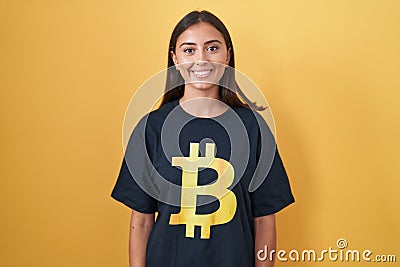 Young hispanic woman wearing bitcoin t shirt with a happy and cool smile on face Stock Photo