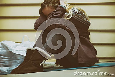 Homeless young teen taking shelter Stock Photo