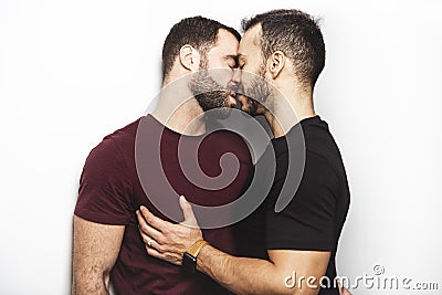 Young homosexuals gay couple love each other on a white background. Stock Photo