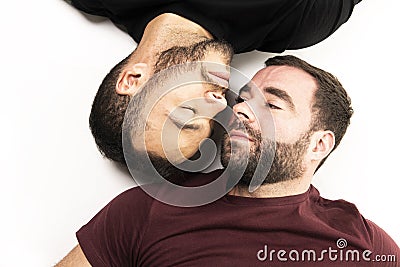 Young homosexuals gay couple love each other on a white background. Stock Photo