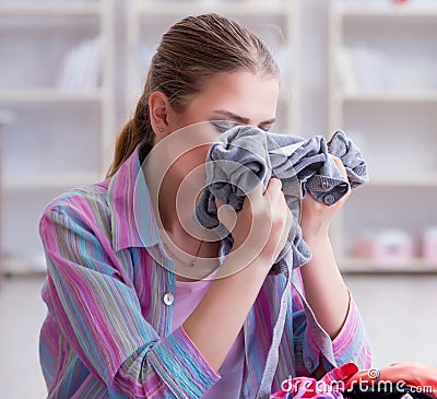 Young housewife doing laundry at home Stock Photo