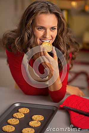 Young housewife eating fresh christmas cookies Stock Photo