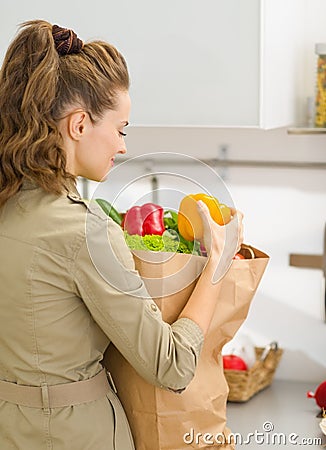 Young housewife examines purchases after shopping Stock Photo