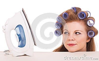 Young housewife looking at iron Stock Photo