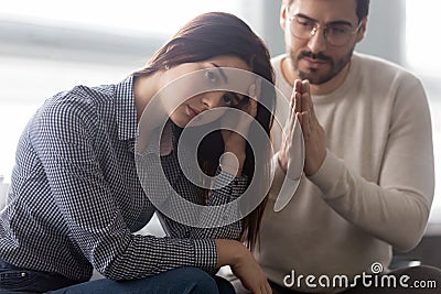 Young husband beg offended wife for forgiveness Stock Photo