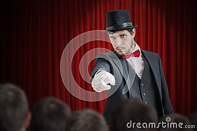 Young illusionist or magician is selecting volunteer from the audience Stock Photo