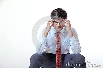 Young indian businessman with headache over white background Stock Photo