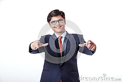 Young Indian Businessman pointing to the front over white background Stock Photo