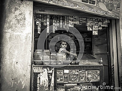 Young Indian child in a shop window Editorial Stock Photo