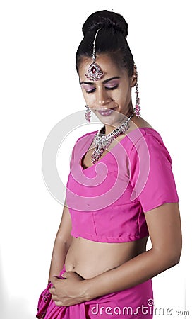 Young Indian female wearing traditional pink sari with jewellery Stock Photo
