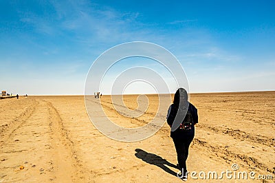 Young indian girl in black dress walking on the rann of kutchh gujarat india Editorial Stock Photo