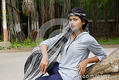 Young Indian girl with short hair wearing headgear and posing for camera, Pune Stock Photo