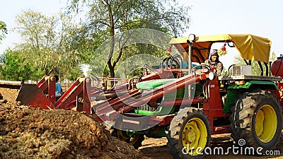 Young Indian man operate new tractor with loder. Agriculture with modern technology Editorial Stock Photo