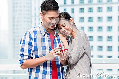 Young Indonesian man makes proposal to girlfriend Stock Photo